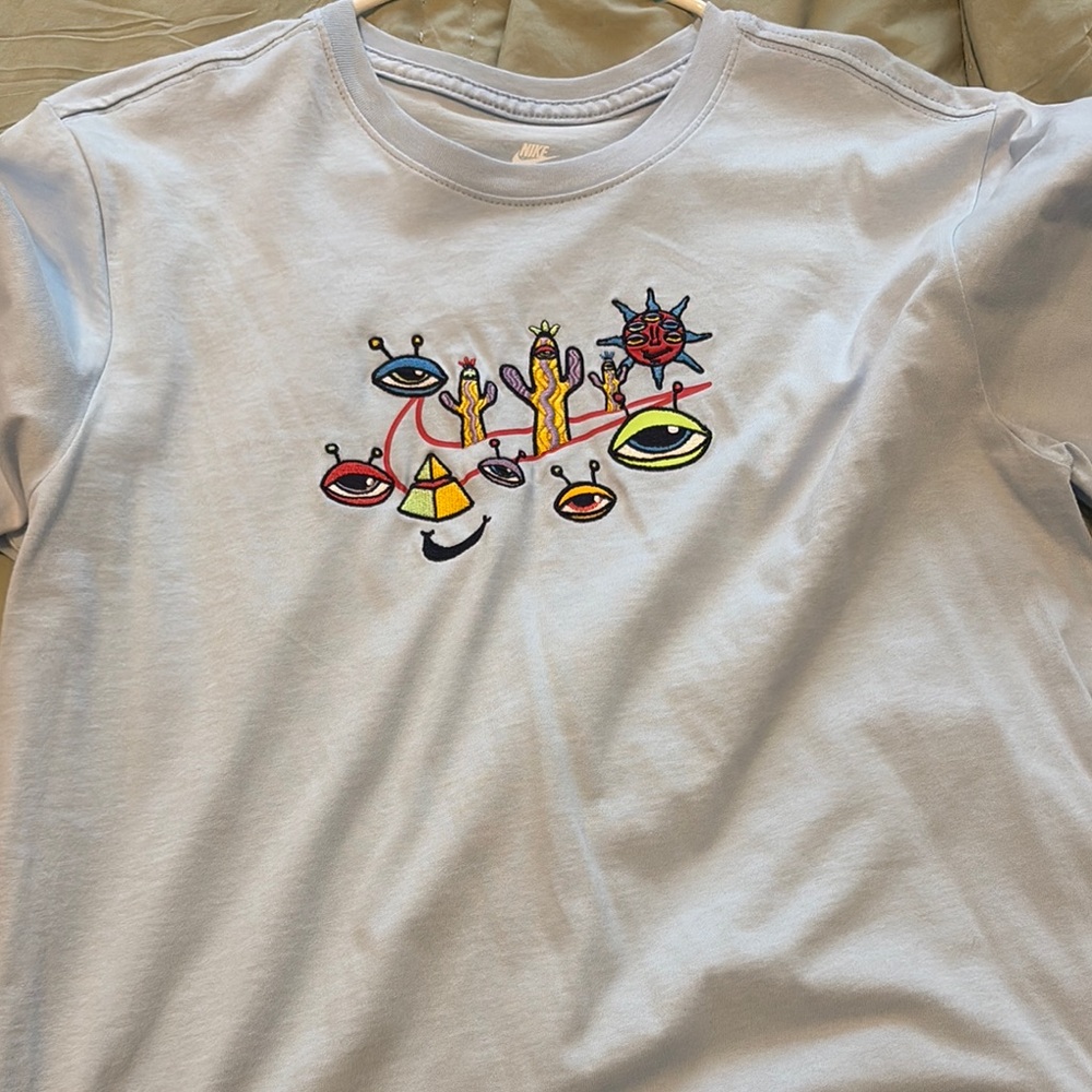 Nike Graphic Tee With Abstract Design - image 1